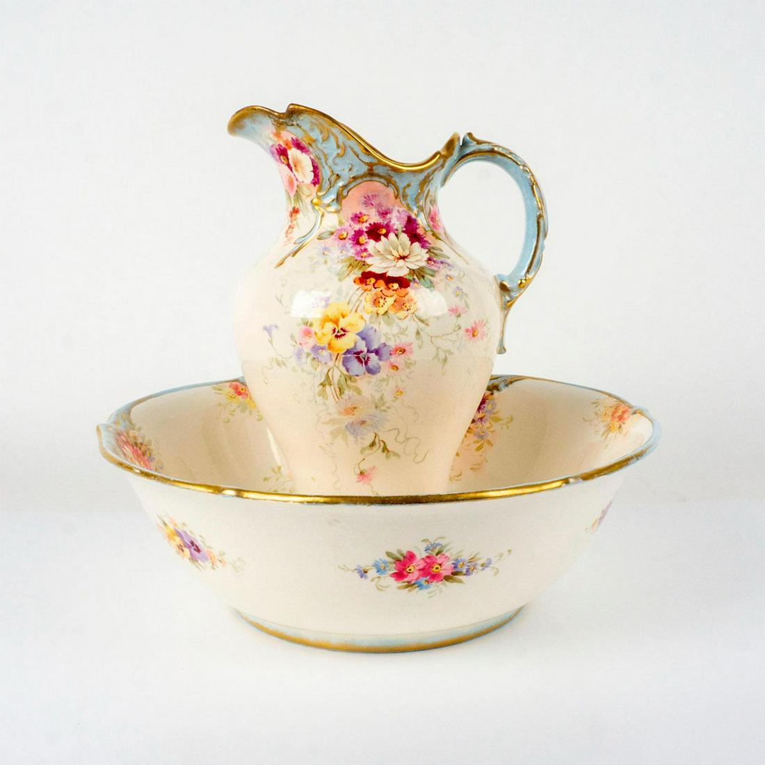 Antique Royal Bonn Gilt Water Jug with Wash Basin: Elegantly decorated with beautifully detailed floral design. Royal Bonn backstamp to bowl. Dimensions of pitcher: 8.5 in. L x 7 in. W x 13.75 in. H. Dimensions of bowl: 16.25 in. Dia. x 5.5 in. H. Man