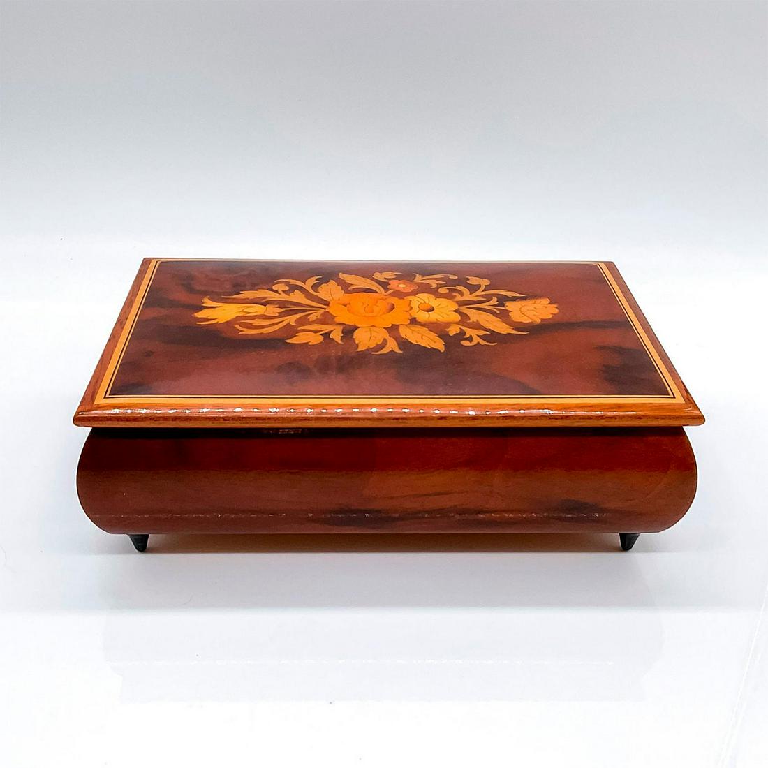 Reuge Italian Handcrafted Inlay Music Jewelry Box: A marquetry wooden box with a floral inlay. Red velvet interior. Melody 'What I Did For Love'. Reuge and 'Made in Italy' stickers on the base. Dimensions: 8"L x 5.25"W x 2.75"H Manufac