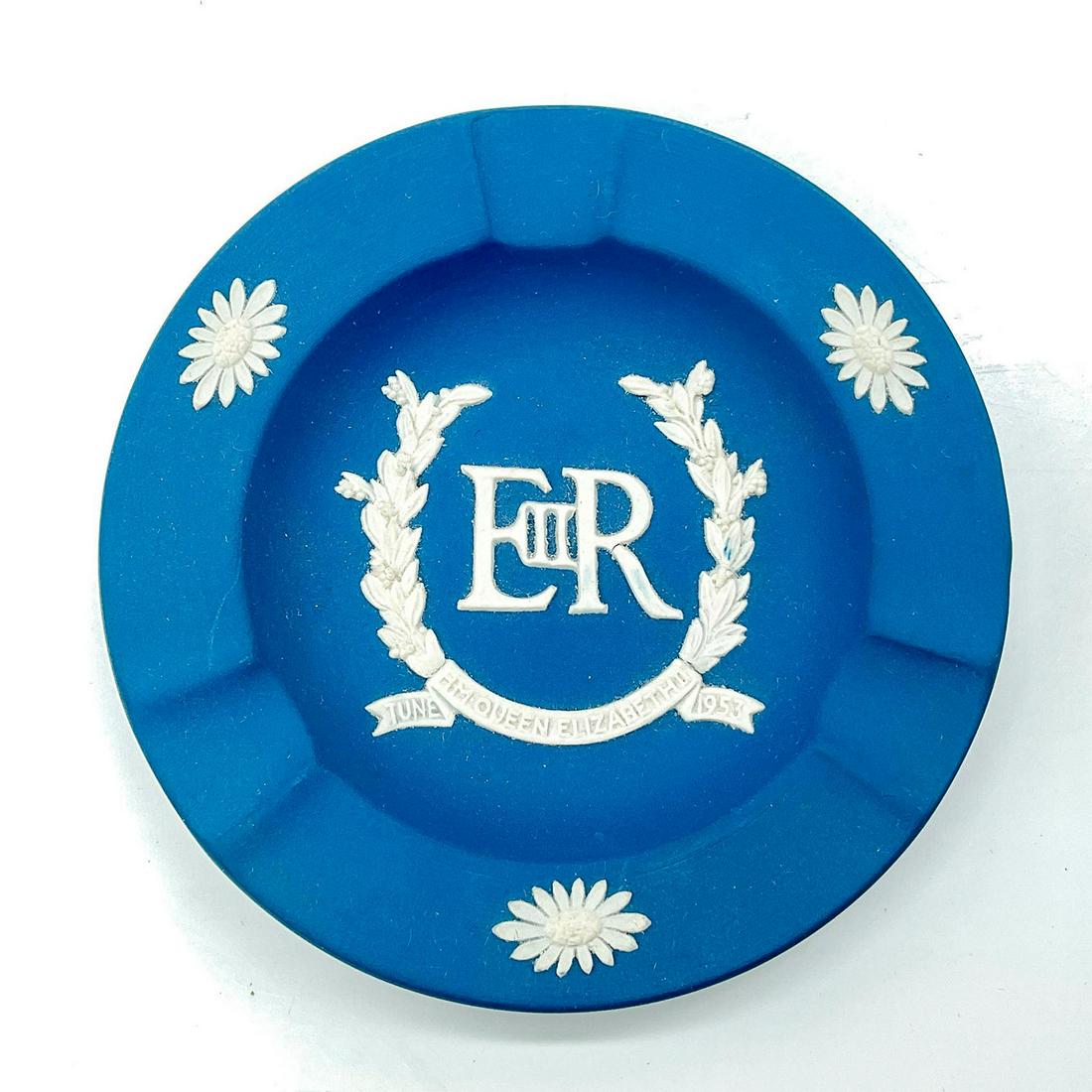 Wedgwood Blue Jasperware Coronation Ashtray: Dark blue matte finish ashtray with three cigarette slots; made in honor of the Queen Elizabeth's coronation. Wedgwood backstamp. Issued: 20th c. Dimensions: 0.5"H x 4.25"Dia. Manufacturer: Wedgwood C