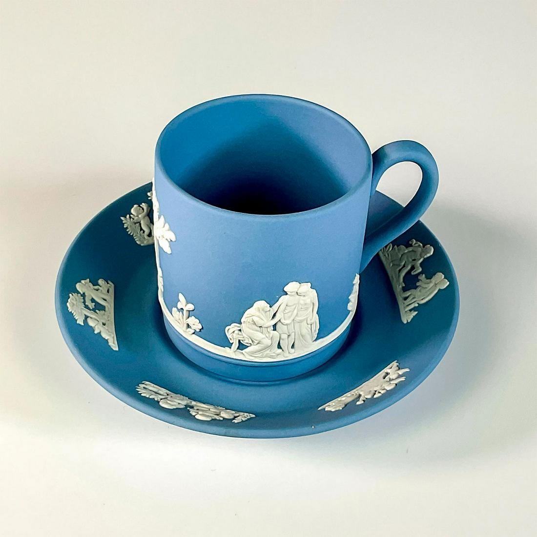 Wedgwood Light Blue Jasper Porcelain Demitasse, Saucer: Lovely set of demitasse and saucer with a raised continual classical ladies on the cup and cherubs on the saucer. Cup measures: 2.25in H x 3in L x 2in D (including handle). Saucer measures: 0.50in H x