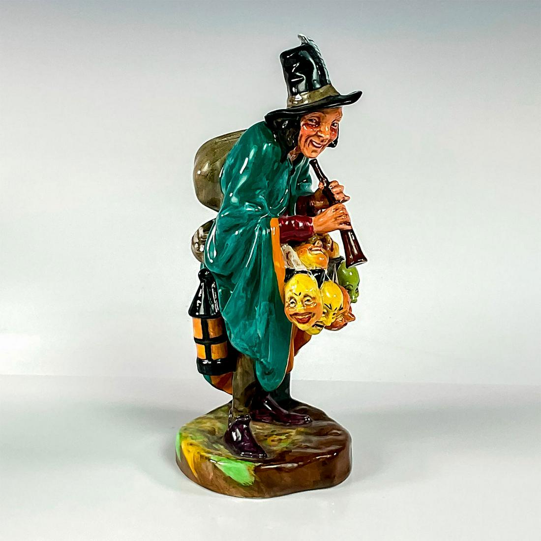 Mask Seller - HN2103 - Royal Doulton Figurine: Artist: Leslie Harradine Issued: 1953 - 1995 Dimensions: 8.5"H Manufacturer: Royal Doulton Country of Origin: England