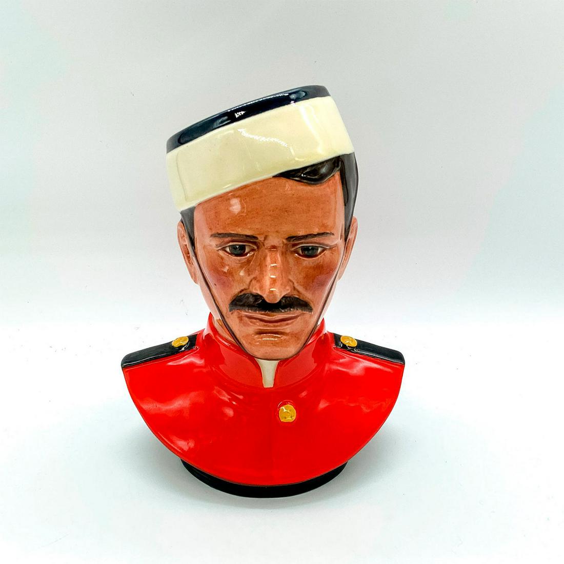R.C.M.P. HN2555 - Royal Doulton Figurine: Royal Canadian Mounted Police R.C.M.P. 1873, Large. HN2555. Centennial commemorative. Glossy finish. Red uniform, white and navy blue hat. Royal Doulton backstamp. Issued: c. 1972 Dimensions: 6"L x 4.