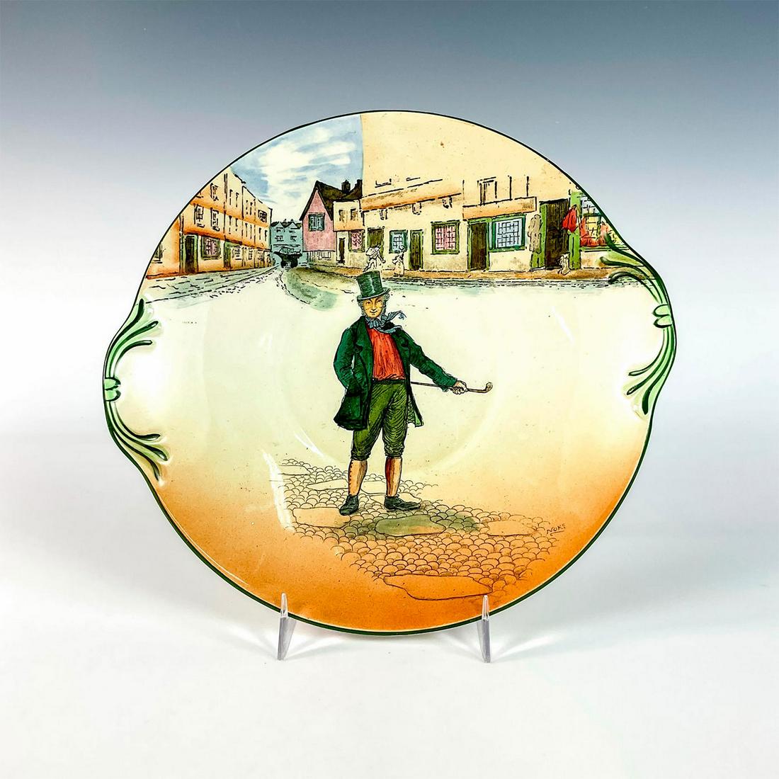 Royal Doulton Dickens Ware Plate, Mark Tapley D2943: Small round cake plate depicting Mark Tapley standing on a cobblestone street. Low relief green floriate decoration. Royal Doulton backstamp. Issued: 1932 Dimensions: 9.5"L x 9"W x 1"H Manufacturer: R