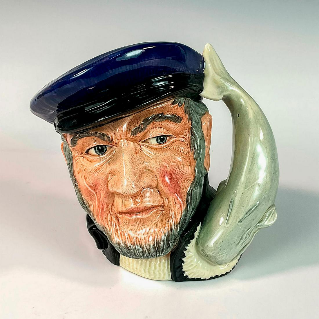 Capt Ahab D6500 - Large - Royal Doulton Character Jug: Blue cap, black coat, white sweater. Captain Ahab sailed the whaler, Pequod, in Herman Melville's great 19th century American classic, " Moby Dick" . He lost a leg and then his life in pursuit of the