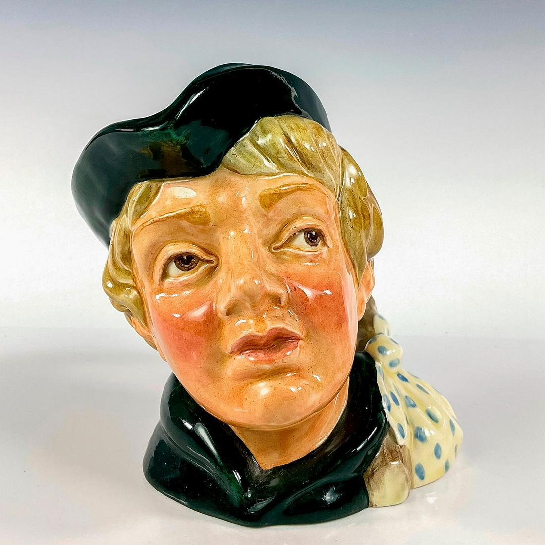 Dick Whittington Old D6375 - Large - Royal Doulton Character Jug: Dark green cap and robes. Royal Doulton backstamp. The first Dick Whittington jug was styled on the character of a poor orphan boy who was employed in a London Kitchen, as described in a play dated 16