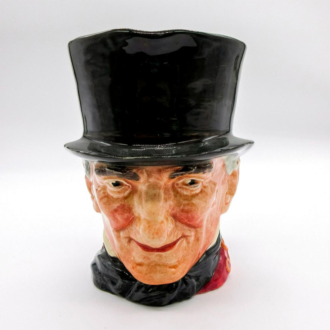 John Peel D5612 - Large - Royal Doulton Character Jug: Black and orange handle. Dark grey hat, maroon coat, dark blue bow tie, black and orange riding crop. Royal Doulton backstamp. Artist: Harry Fenton Issued: Unknown Dimensions: 6.5"H Manufacturer: Roya