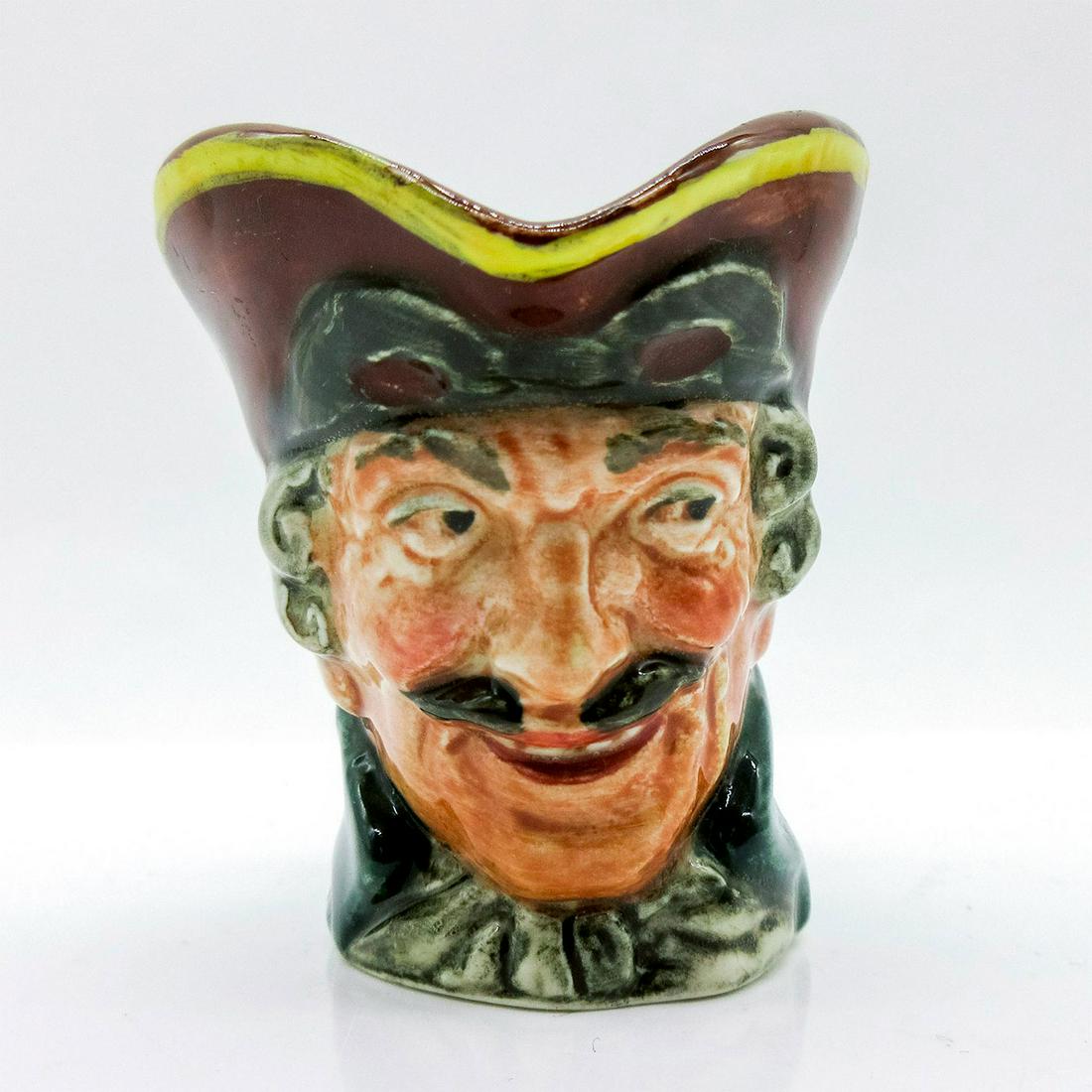 Dick Turpin D6128 (Pistol Handle) - Mini - Royal Doulton Character Jug: Style One, pistol handle. Brown hat; mask up; green coat; white cravat. Dick Turpin (1705 - 1739) joined forces with fellow highwayman Tom King, whom he accidentally shot. Before he died, King betraye