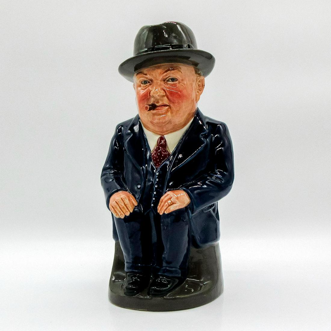 Cliff Cornell (Dark Blue Suit, Large) - Royal Doulton Toby Jug: Dark Blue Suit; red tie with cream polka dots. Part of the Men of History Series. Royal Doulton backstamp. Issued: 1956 Dimensions: 9"H Manufacturer: Royal Doulton Country of Origin: England