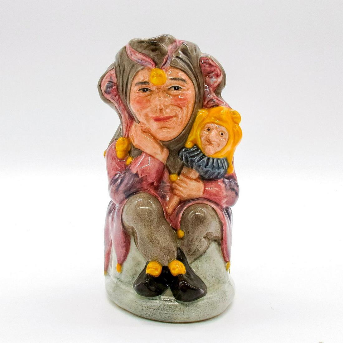 Jester D6910 - Royal Doulton Toby Jug: Mauve and brown costume with yellow bobbles. Series: Jesters. Royal Doulton backstamp. Artist: Stanley J. Taylor Issued: 1992 Dimensions: 5''H Edition Number: 2371 Edition Size: 2500 Manufa