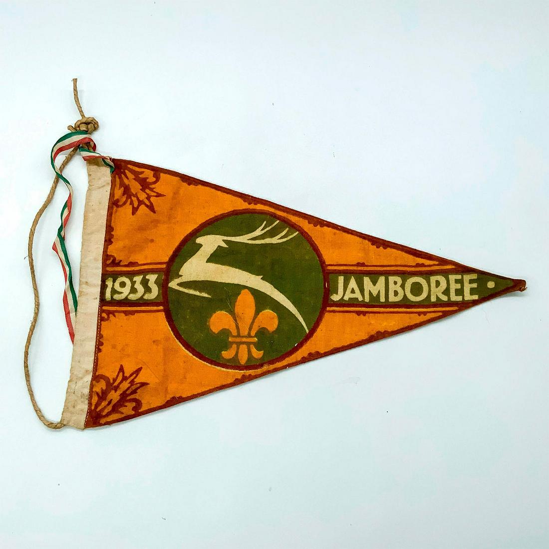 1933 Fourth World Scout Jamboree Pennant, Godollo, Hungary: In green, orange, and beige coloration, in triangular shape, with attached twine. With ribbon in Hungarian flag colors. Depicts the â€˜Miraculous Stagâ€™ of Hungary. Dimensions: 12.25"L x 7.5