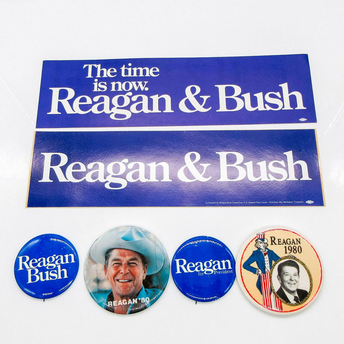6pc Reagan Political Campaign Buttons & Stickers Set: Includes: four buttons with one stating "Reagan for President" on front; one stating "Reagan Bush"; one stating "Reagan â€˜80" with image of Reagan in cowboy hat; and one s