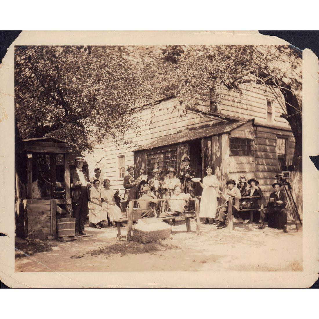 Original Monochrome Photograph, Sunday Gathering: Featuring community members assembled together outside for fellowship and sharing. Presumably a film still or scene from movie released sometime between late 19th to early 20th century. Issued: 1855-1