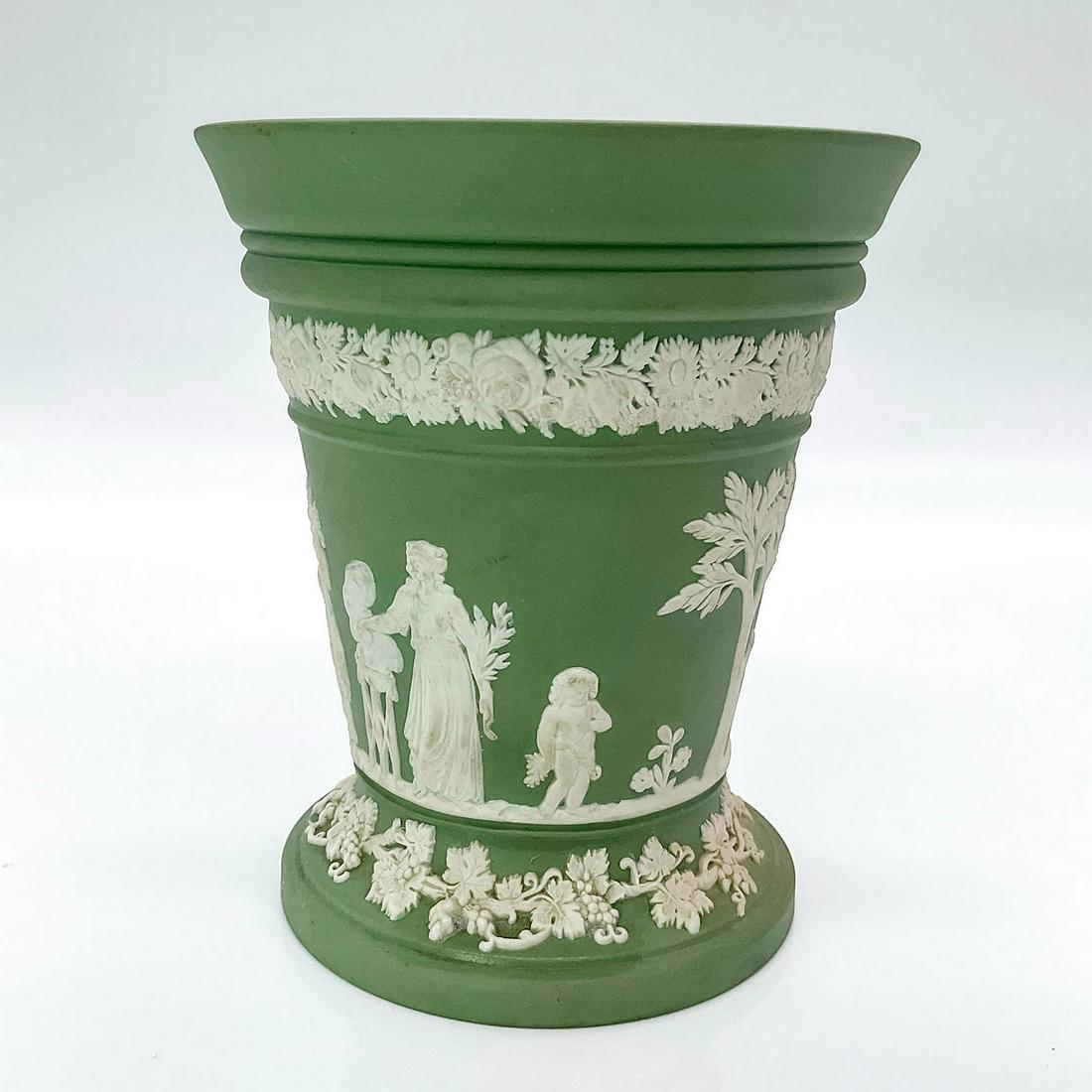 Wedgwood Jasperware Vase, Sacrifice Figures: Sage green vessel decorated in a beautiful neoclassical relief of sacrifices on body. Floral and foliage patterns around. Wedgwood Made in England impressed to bottom. Issued: c. 1930 Dimensions: 3.75
