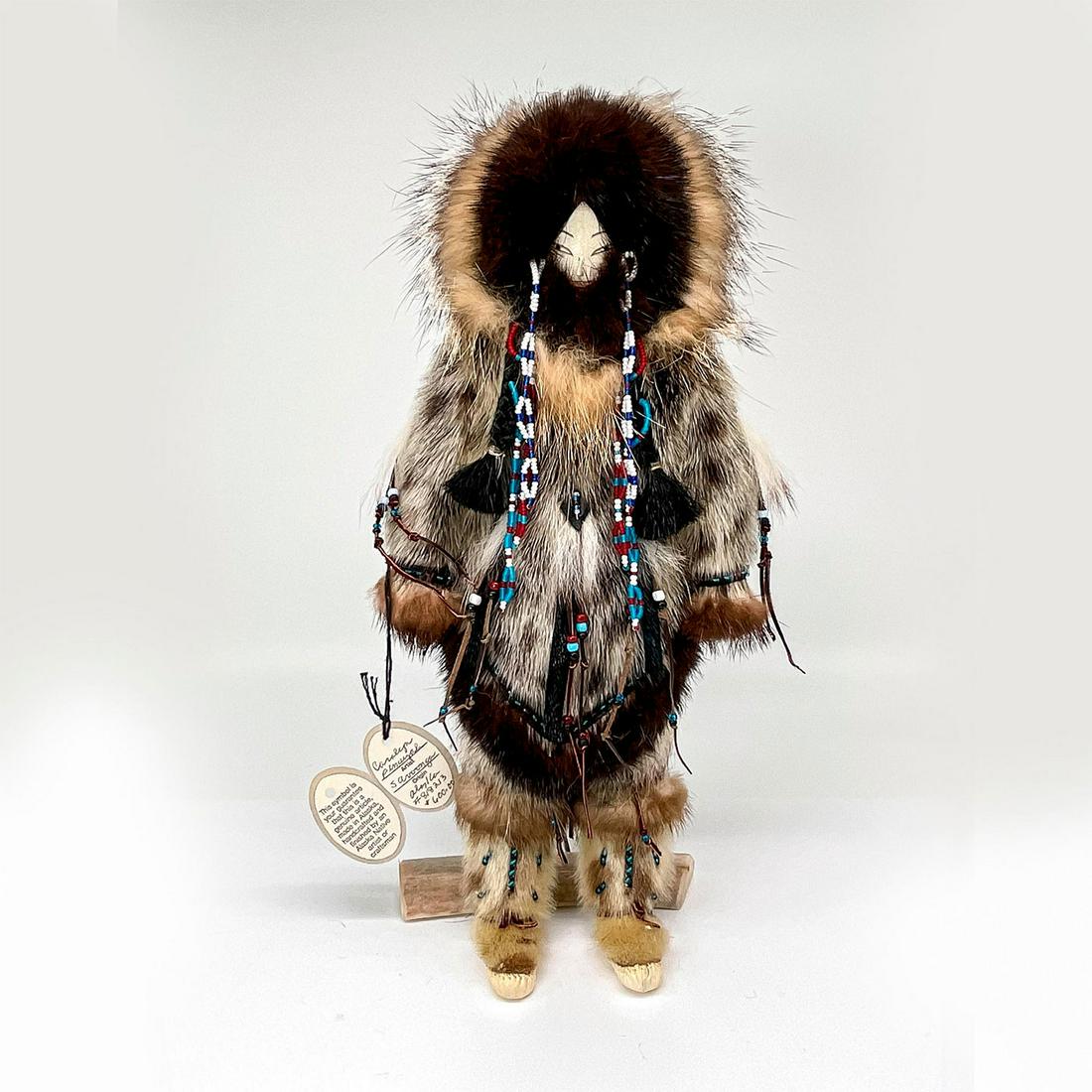 Carolyn Penayah Handcrafted Inuit Yupik Doll from Alaska: Handmade doll with detailed beadwork and wearing traditional garment. Certificate of Authenticity included. This item has a base made of bone or antler included. Artist: Caroline Kava Penayah Dimensio