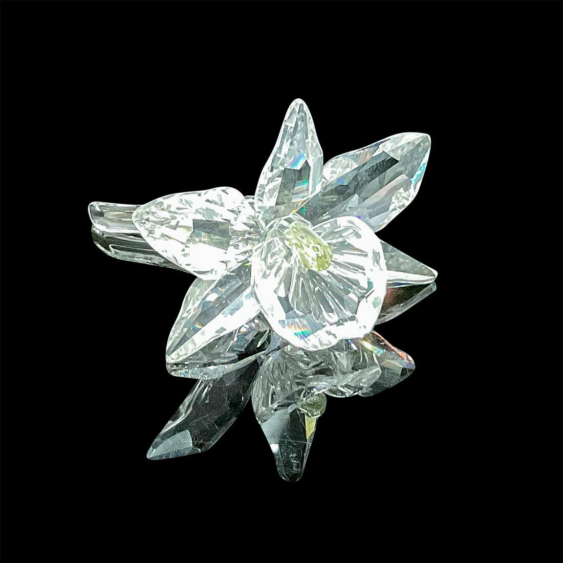 Swarovski Crystal Figurine, Light Yellow Orchid: A single stunning blossomed orchid in clear faceted crystal with a pale yellow center. Swarovski acid mark. This item has its original box: 6.25in W x 4.75in H. Artist: Michael Stamey Issued: 1996 - 2