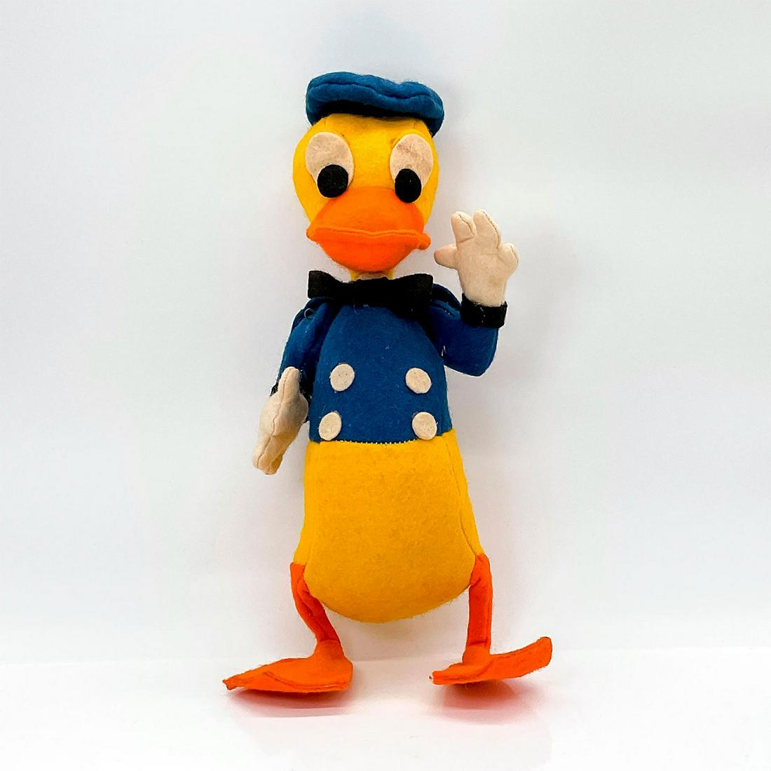 1964 Walt Disney Donald Duck Felt Toy with Movable Arms: Donald Duck with movable shoulder joints. Maker's tag. Dimensions: 6"L x 4"W x 12"H Country of Origin: USA