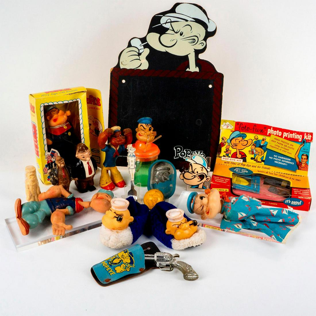16pc Popeye and Wimpy Collectibles Set: Includes: 1 Popeye The Sailor Man doll in box by Uneeda, 1 photo printing kit in box; 1 pair of slippers; 1 gun with holster; 1 sippy cup; 1 fork; 1 metal dish; 1 ball; 1 hand puppet; 1 figural soap;
