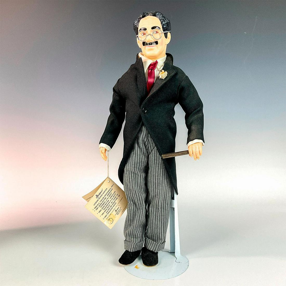 Effanbee Groucho Marx Doll 5th of the Legend Series w/Box: Groucho Marx doll from the Legend series with glasses, swallow tailcoat, and red tie. This item has its original box with dimensions 5"L x 10"W x 20"H and hang tag. Issued: 1983 Dimensions: 3.5"L x 7"