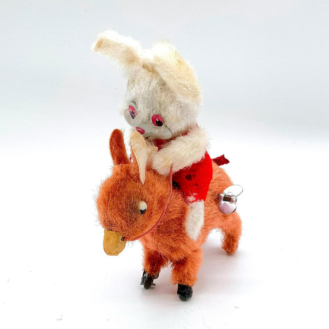 Bunny Jockey Wind Up Toy: Depicts cute white bunny riding a donkey. Donkey moves after being wound with key. Dimensions: 5"L x 2"W x 6.5"H Country of Origin: Japan