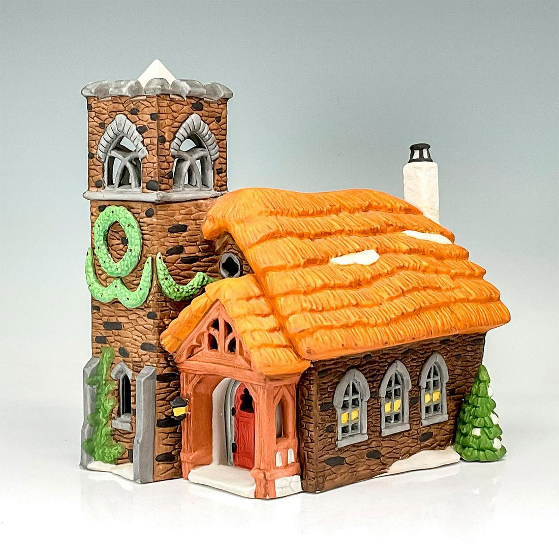 Department 56 Figure, Ivy Glen Church: Part of the Dickens' Village Series. Hand-painted porcelain figure featuring a snow laden and Christmas decorated church with thatched roof. Department 56 backstamps. This item has its original box. B