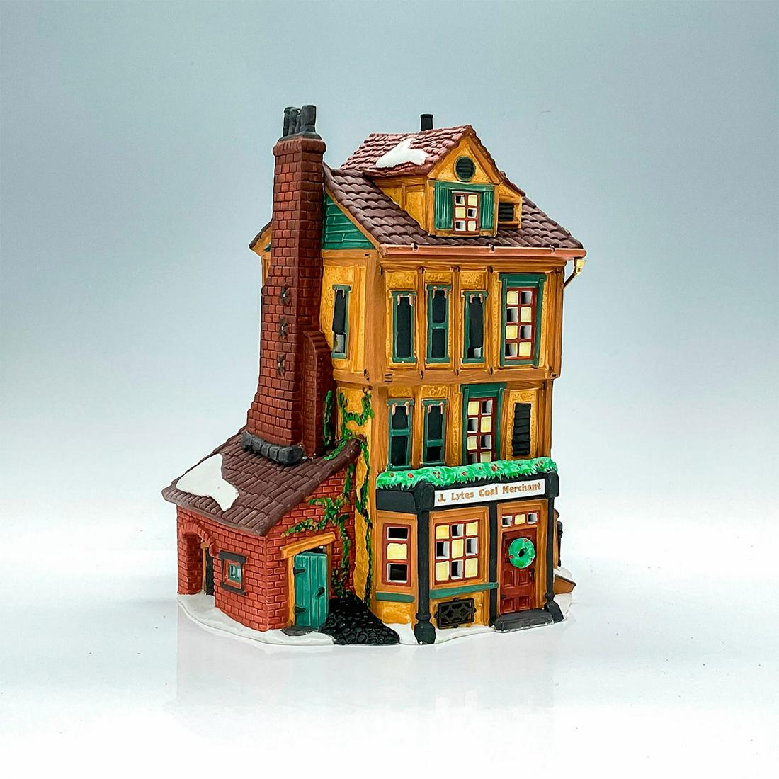 Department 56 Figure, J. Lytes Coal Merchant: Part of the Dickens Village Series. Porcelain, depicting a tall building housing a coal merchant. Coverings for the upper windows are metal plates hinged to the window instead of glass panes with ligh