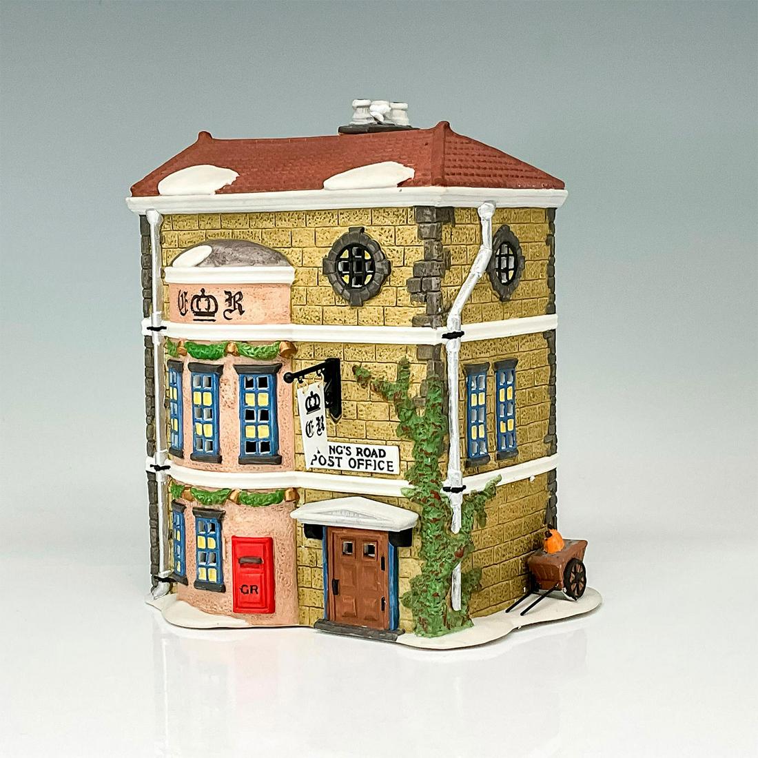 Department 56 Figure, King's Road Post Office: Part of the Dickens' Village Series. Hand-painted porcelain figure modeled as the King's Road Post Office decorated for Christmas. Department 56 backstamp. This item has its original box. Box dimensio