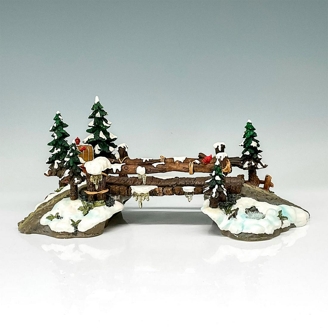Department 56 Figure, Mill Creek Wooden Bridge: Department56 figurine depicting snowy rural bridge. The bridge is started by a rocky path on both ends with wildlife and pine trees incorporated throughout. This item has its original box. The origina