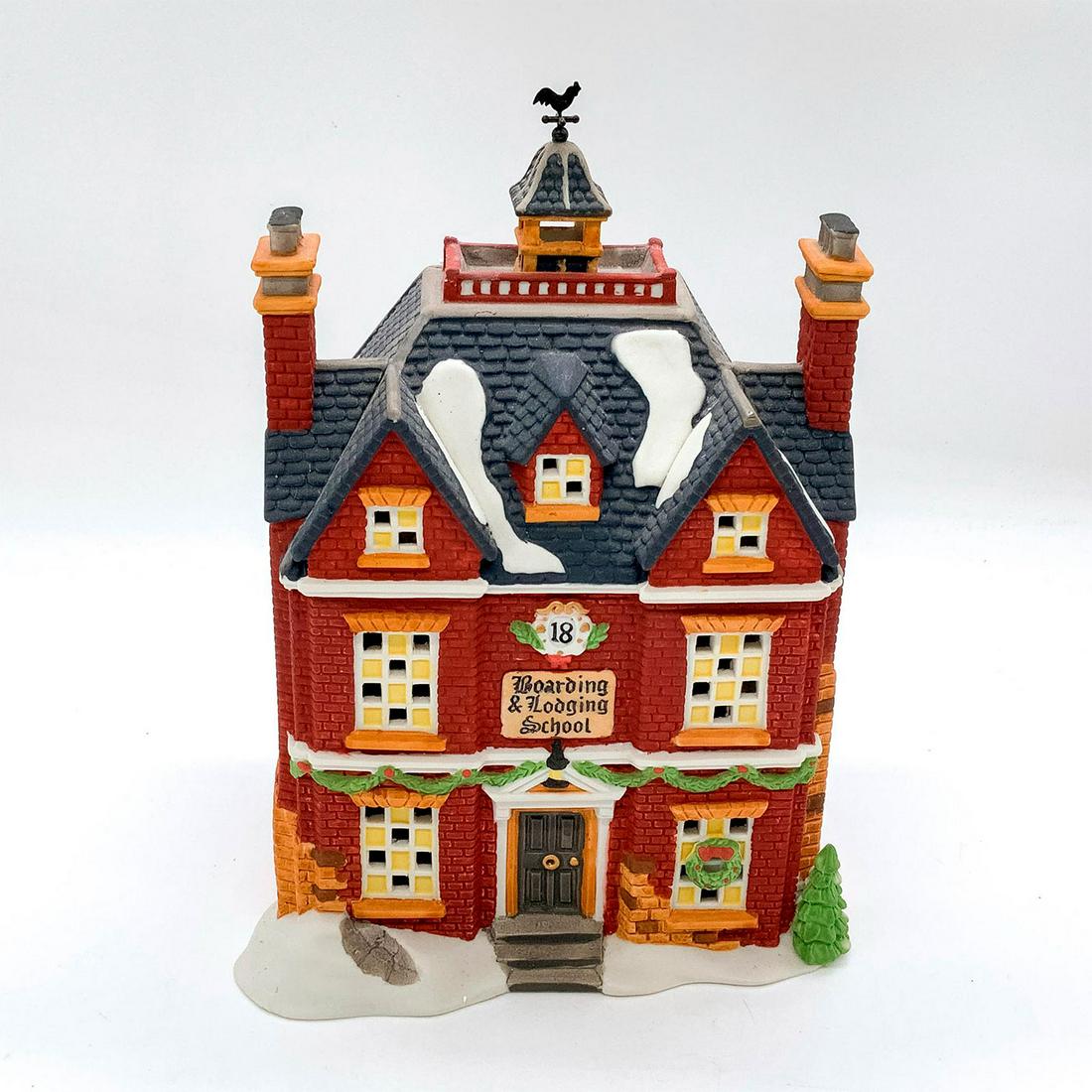 Department 56 Figurine, Boarding and Lodging School: Part of the Dickens Village Series and The Heritage Village Collection. Commemorating the 150 Year Anniversary of A Christmas Carol. Hand painted porcelain, depicting quaint building decorated for Chr