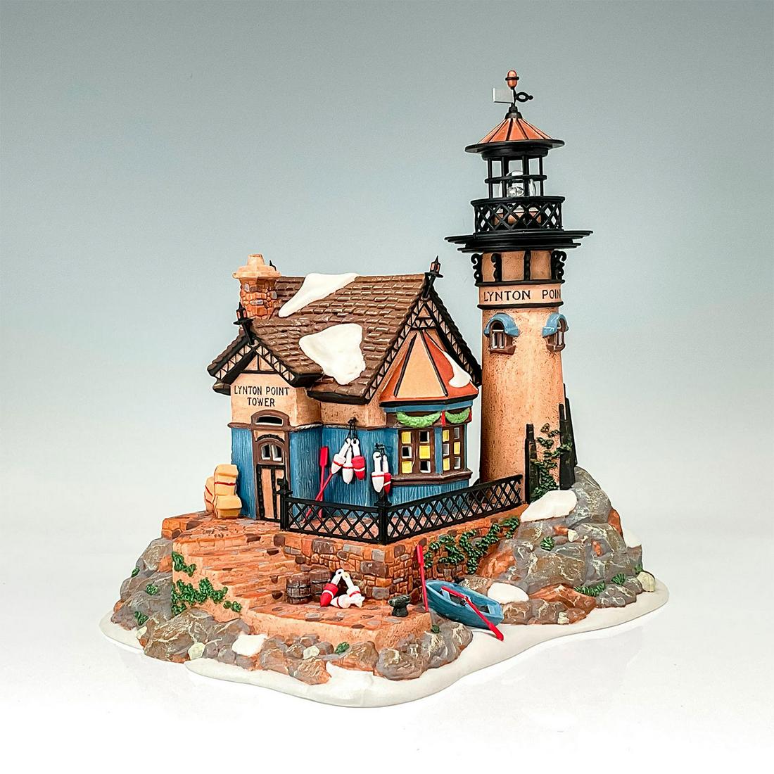 Department 56 Figurine, Lynton Point Tower: Department 56 figurine "Lynton Point Tower". Rustic stony lighthouse alongside lighthouse office. This item has its original box. Original box dimensions: 10.75"H x 9.5"W x 12"H. Issued: 1998-2001 Dim