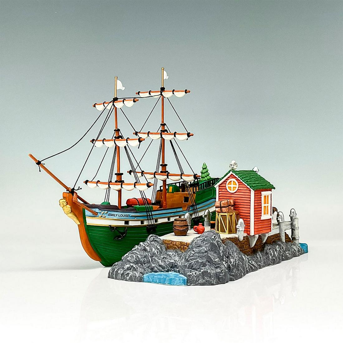 Department 56 Figurine, The Emily Louise: Department 56 Figurine depicting the "Emily Louise" sailboat. An old fashioned forest green sailboat with two masts and a golden figurehead. This item has its original box. The original box's dimensio