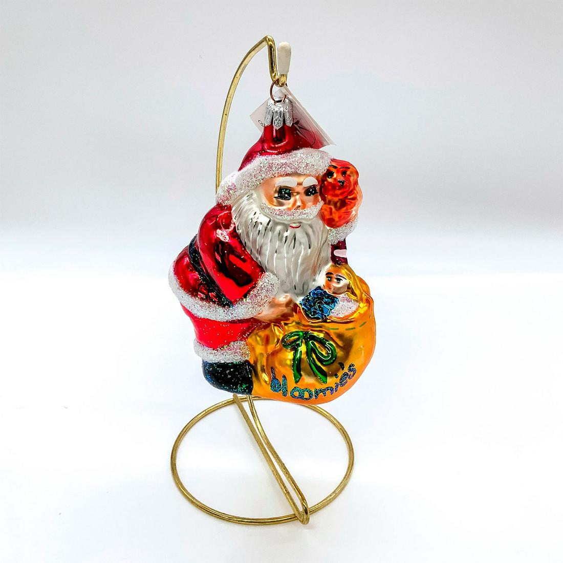 Christopher Radko Christmas Ornament, Bloomieï¿½s Santa Claus: Depicts happy Santa with sack full of toys. Hand painted glass with glitter accents. Christopher Radko backstamp to top. This item has its original box with dimensions: 3.75 in. L x 3.5 in. W x 7 in. 