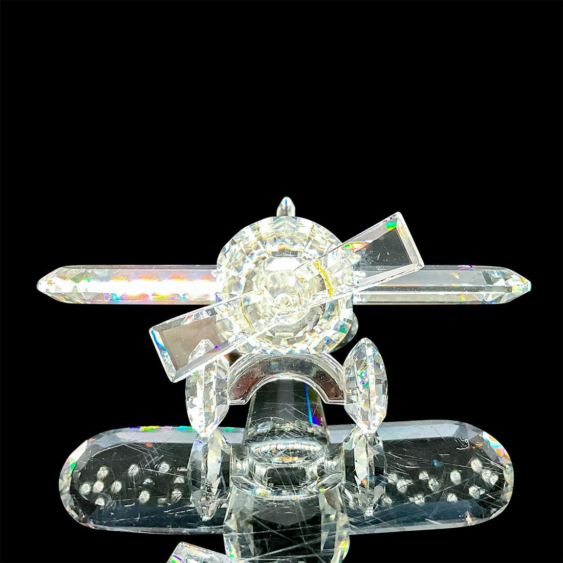 Aeroplane - Swarovski Crystal Figurine: Crystal aeroplane was part of the When we were Young theme. Swarovski etched backstamp. This item has its original box. Box measures: 5"W x 4"H. Artist: Adi Stocker Issued: 1990-1999 Dimensions: 2.75"