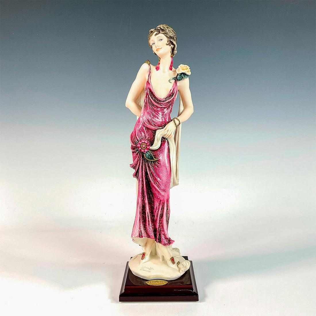 Capodimonte Giuseppe Armani Figurine, Sara: Matte and glossy finished figurine modeled as a 1920s styled woman wearing a revealing fuchsia colored gown with rose pin and white sash. Fixed to square dark wood base. Giuseppe Armani impressed to b