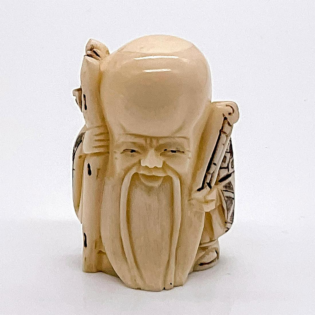 Japanese Inked Carved Bone Fukurokuju Netsuke: Hand carved figure of the god of longevity. Japanese characters markings on the base. Dimensions: 1.5"L x 1.25"W x 2"H Country of Origin: Japan