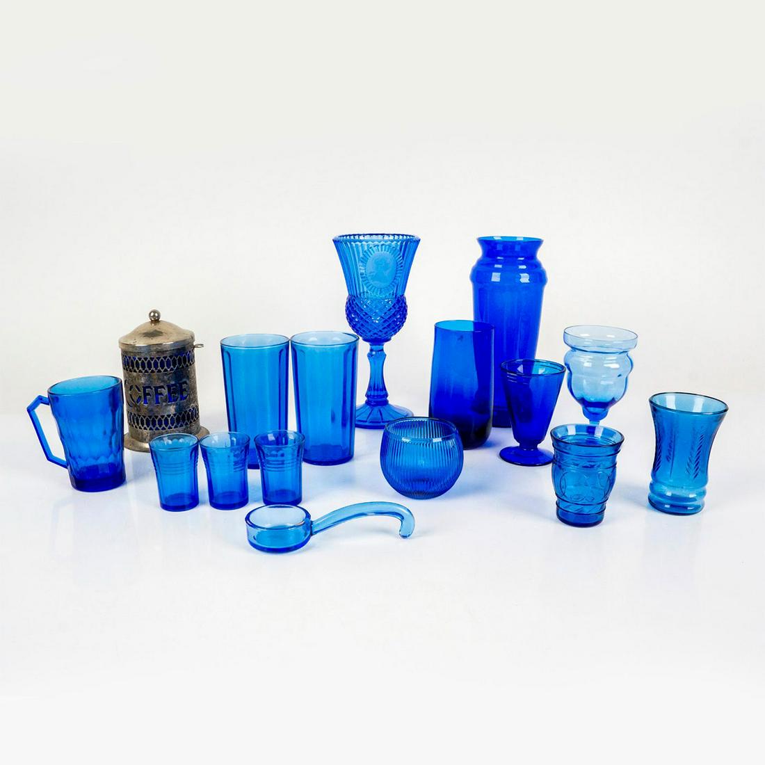 16pc Cobalt Blue Glassware Grouping: Mid-century cobalt glasses, vases, and jars including: silverplated lidded coffee jar with cobalt insert, Avon George Washington goblet Fostoria wine glass or candle holder, 3 small ribbed shot glasse