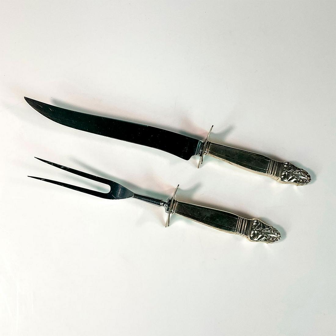 Insico Stainless Steel Carving Set: Elegant meat carving set consisting of a large knife and fork in an intricate textured pattern. Marked Insico Stainless to blades. Knife measures: 13.25in L x 1.75in W. Fork measures: 11.25in L x 1.75