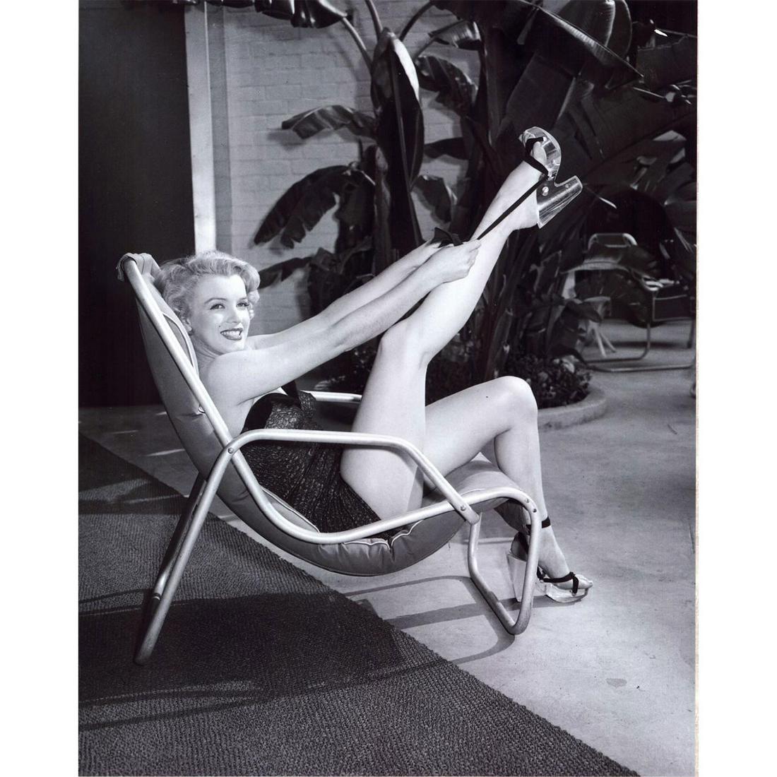 Frank Worth (American 1923-2020) Marilyn Monroe Photograph: Archival pigment print on Fugi paper of Marilyn Monroe in a lounge chair with leg up. Issued: 1949 Dimensions: 16"L x 20"H