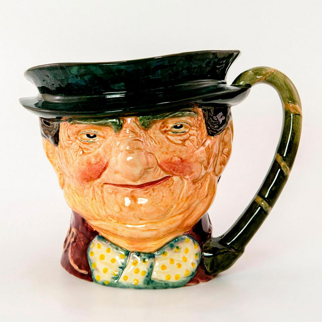 Tony Weller D5888 - Musical - Royal Doulton Character Jug: Plays "Come Landlord Fill the Flowing Bowl". Dark grey hat, maroon coat and white bow with yellow spots. Royal Douoton marking on the bottom. Good condition. Artist: Leslie Harradine and Harry Fenton 