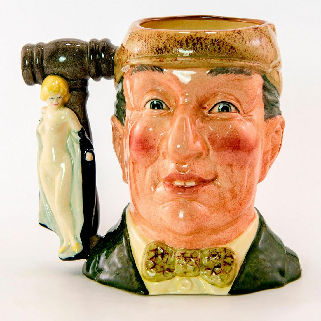 Auctioneer D6838 - Large - Royal Doulton Character Jug: Green coat and bow tie, light brown cap. Handle; auctioneer's gavel and The Bather HN687. Royal Doulton backstamp. A Special edition of 5000 from "The Collecting World" series. Artist: Geoff Blower Is
