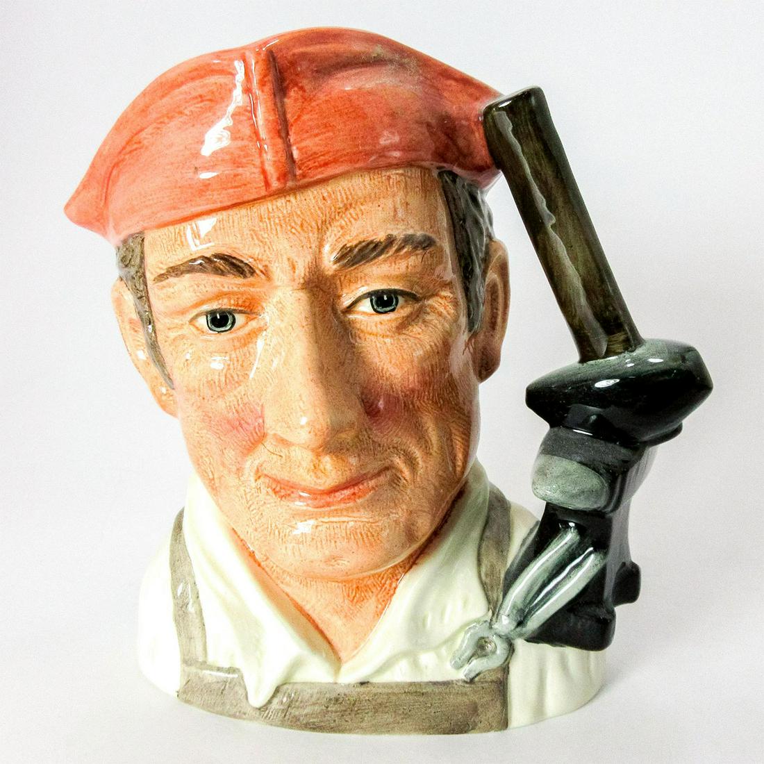 Blacksmith D6571 - Large - Royal Doulton Character Jug: Salmon hat, white shirt, light brown apron. Series: Characters from Williamsburg. Royal Doulton backstamp. Artist: David B. Biggs Issued: 1963 - 1983 Dimensions: 7.25"H Manufacturer: Royal Doulton