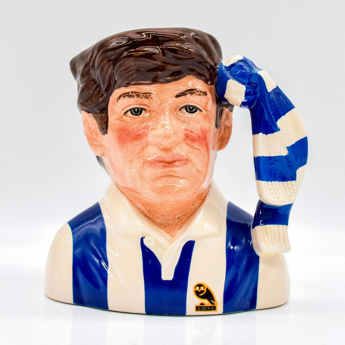 Sheffield Wednesday D6958 - Small - Royal Doulton Character Jug: Blue and cream striped uniform. This jug was sold exclusively through John Sinclair of Sheffield, England. Series: The Football Supporters. Royal Doulton backstamp. Artist: Stanley J. Taylor Issued: 1