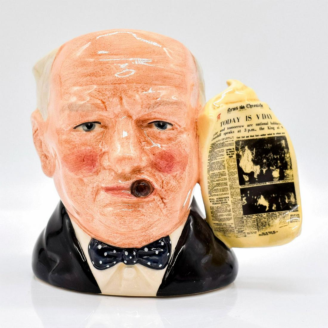 Winston Churchill D6934 (News Chronicle Victory Handle) - Small - Royal Doulton Character Jug: Style Two, news chronicle victory handle. Black, grey, white and cream coloration. Royal Doulton backstamp. Artist: Stanley J. Taylor Issued: 1992 - 2002 Dimensions: 4"H Manufacturer: Royal Doulton <