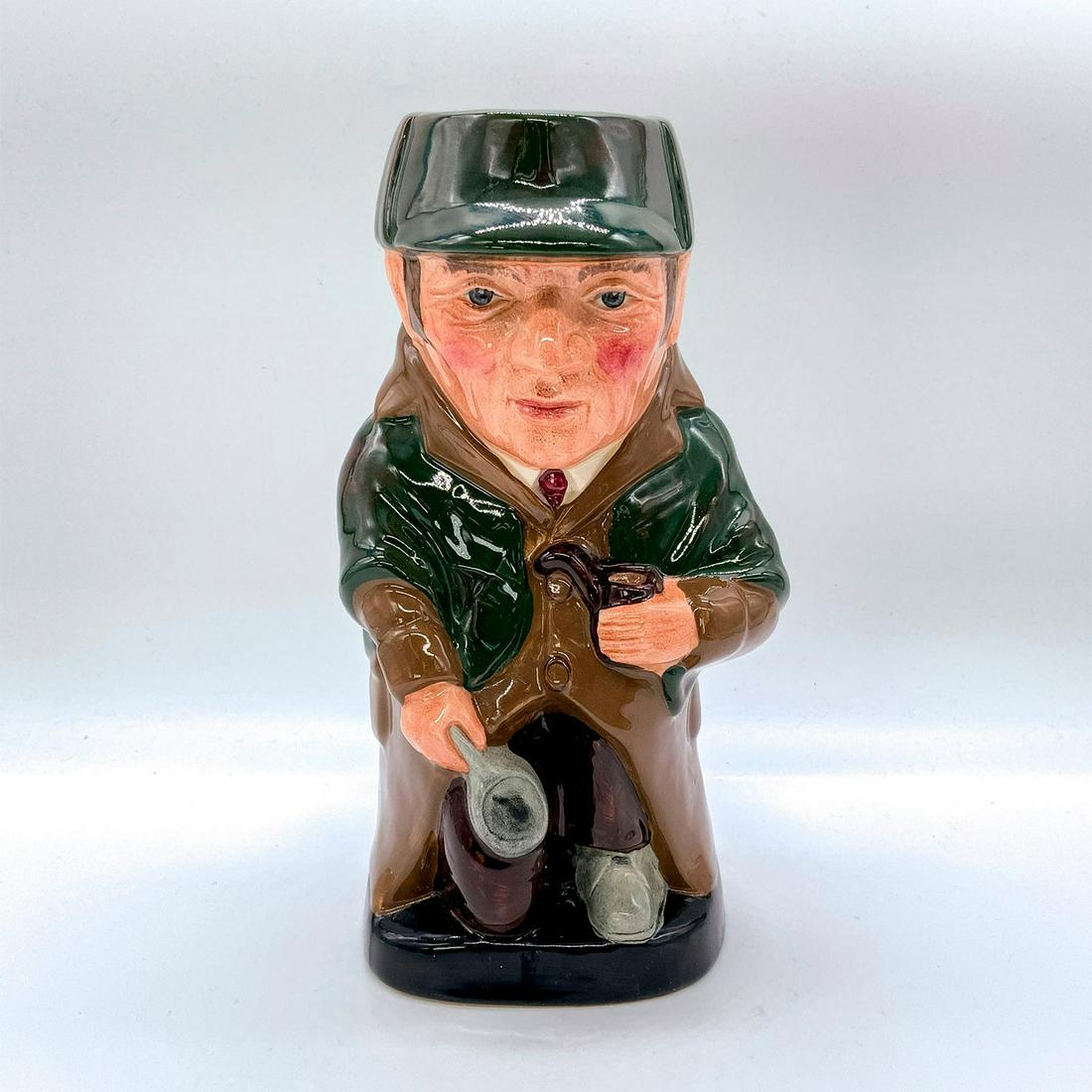 Sherlock Holmes D6661 - Large - Royal Doulton Toby Jug: Part of the Literary Characters Series. Issued to commemorate the 50th anniversary of the death of Sir Arthur Conan Doyle (1859-1930). Depicted wearing green hat and cloak, with brown coat. Royal Doul