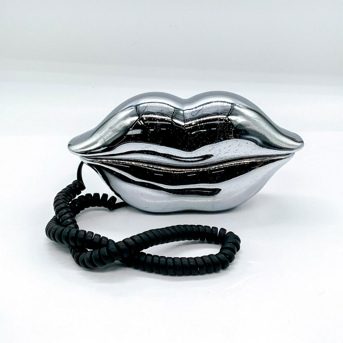 Vintage 80s TeleQuest Corded Phone, Hot Lips: Depicts lips in silver coloration, with black cord. Telequest backstamp. This item has no reserve. Dimensions: 8"L x 2.5"W x 4.25"H Manufacturer: TeleQuest Country of Origin: Hong Kong
