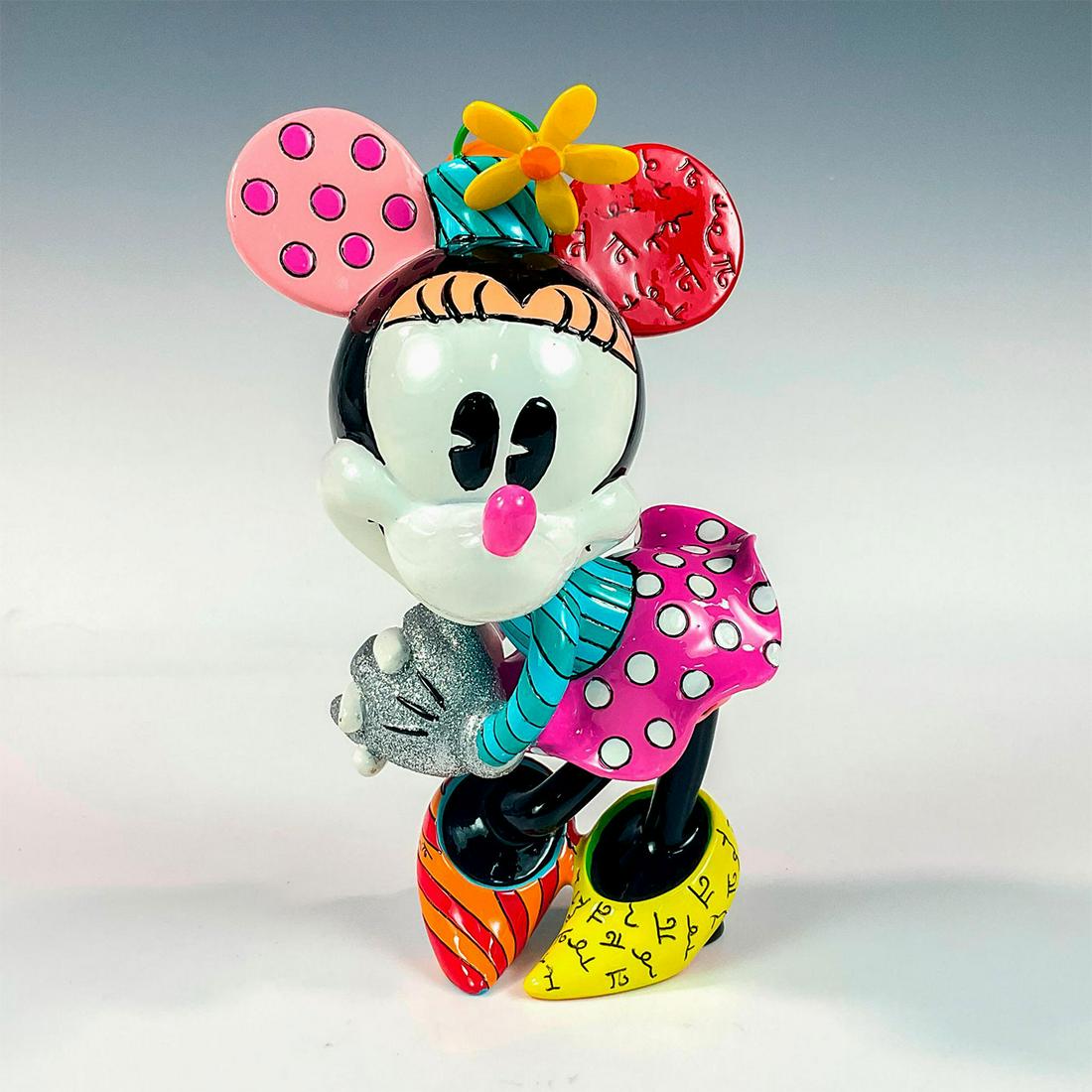 Disney Romero Britto Figurine, Minnie Mouse: Adorable resin character with colorful dress and shoes. Silver sparkly gloved hands. Disney Britto backstamp. Romero Britto signature on foot. Artist: Romero Britto Issued: 2014 Dimensions: 4"L x 3"W 