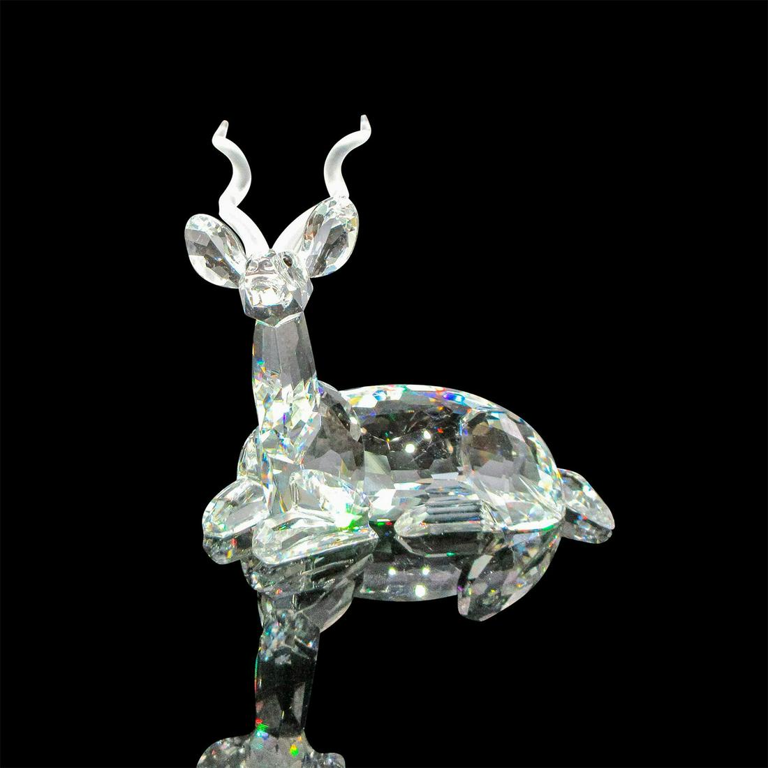 Swarovski SCS Crystal Figurine, Kudu: Inspiration Africa figural with clear, faceted body, black inset eyes and frosted antlers. Swarovski backstamp. DO1X941/175 703. This item has its original box: 7.5"L x 7.5"W x 6.5"H. Artist: Michael 
