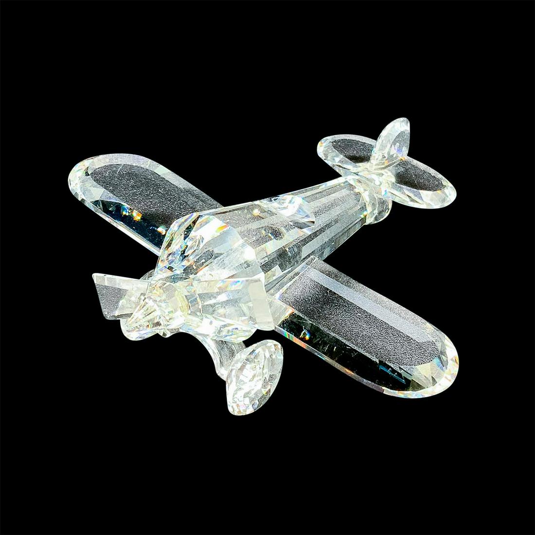 Swarovski Crystal Figurine, Aeroplane: Part of the Silver Crystal Collection. Lead crystal. In clear finish, multifaceted. Swarovski acid mark. This item has its original box with dimensions: 4 in. D x 5 in. H. Artist: Adi Stocker Issued: 