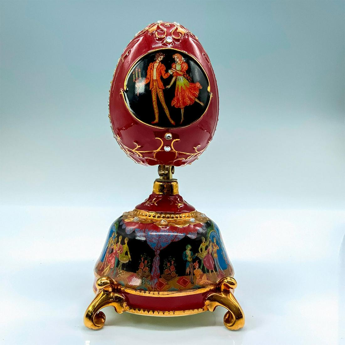 Nutcracker Ballet Collection Music Box Clara & the Nutcracker: Title: The Nutcracker Ballet Collection Music Box, Clara and the Nutcracker. A crimson-colored music box depicting moments of the Nutcracker Ballet with the center piece able to open to reveal a figur