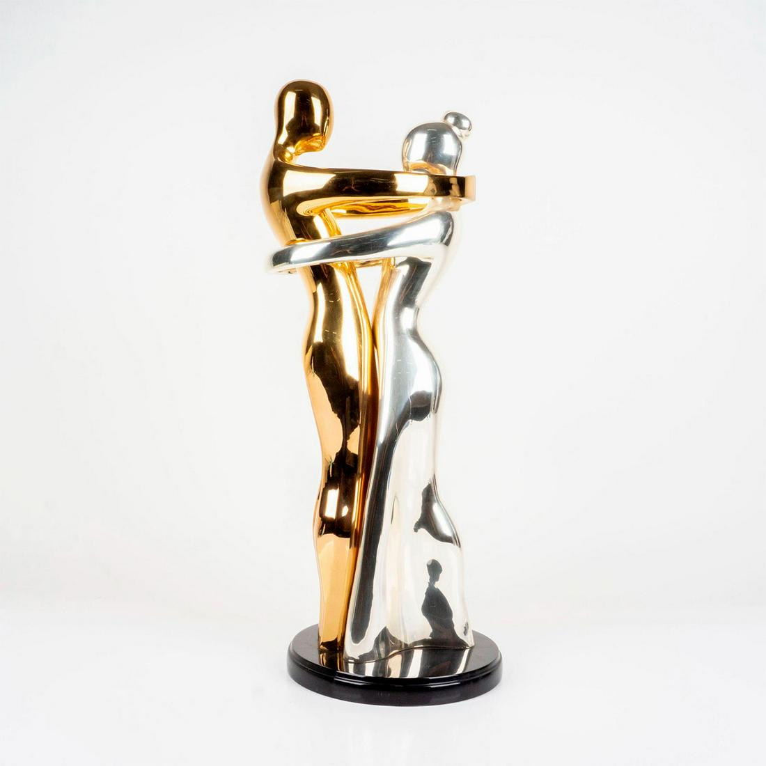 24K Gold and Silver Wedding Rings Couple Sculpture: A stunning statue of a 24k groom wrapped around his beautiful silver bride. Attached to a black round base. Dimensions: 11"L x 9.5"W x 24"H Country of Origin: Mexico Manufacturer: Dâ€™Argenta