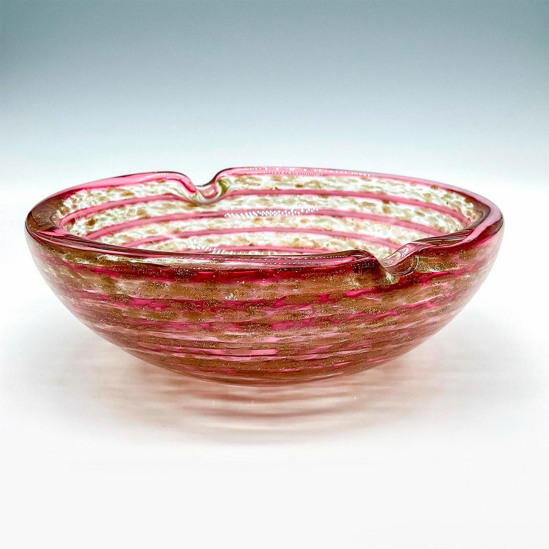 Murano Glass Swirl Ashtray: Clear glass exterior with a swirling pink and gold interior. A superb piece of opt art blown glass. Dimensions: 5.75"W x 2"H